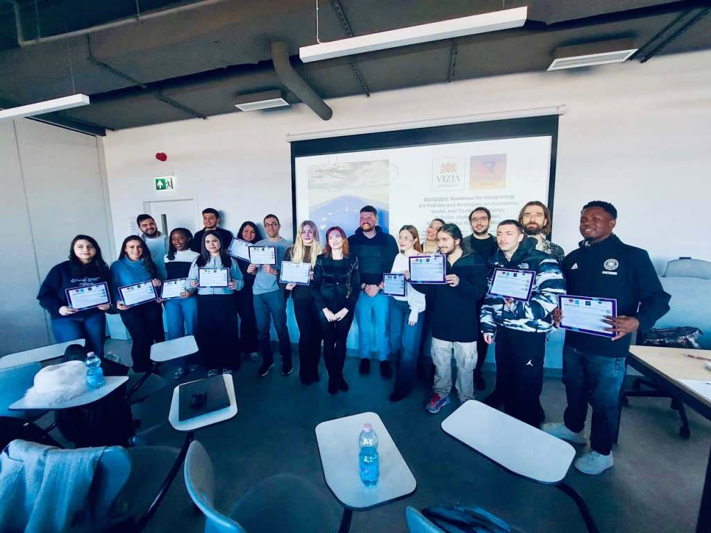 ROAD2EU Economic Track participants displaying Certificates of Attendance at VIZJA University.